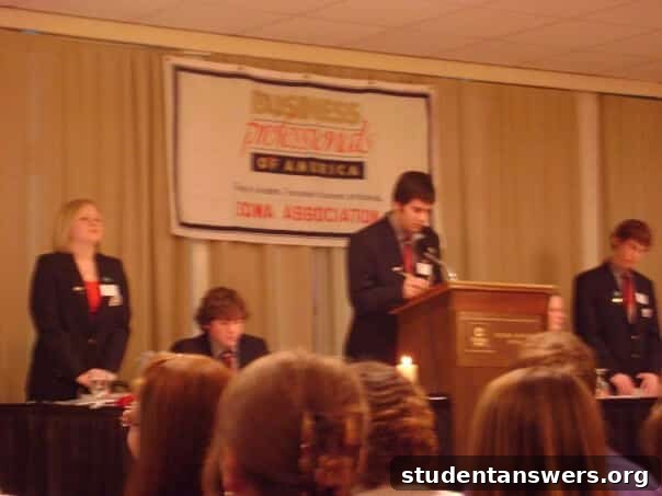A high school photo of the author with a bad haircut giving a speech.