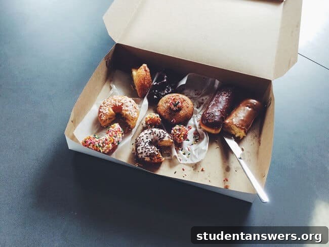 A box of colorful donuts on a wooden surface, symbolizing a tempting but unhealthy choice for the mind.