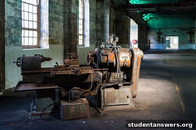 An old, rusted, and abandoned piece of industrial machinery in a derelict factory.