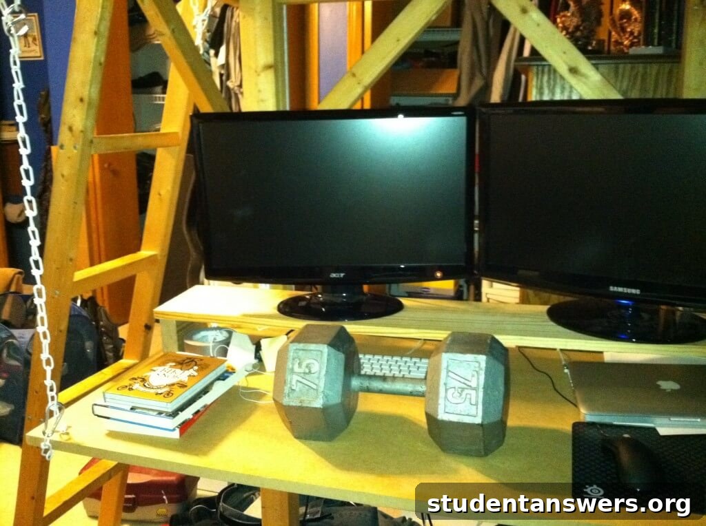 A 75-pound dumbbell resting on the finished hanging desk, demonstrating its strength.