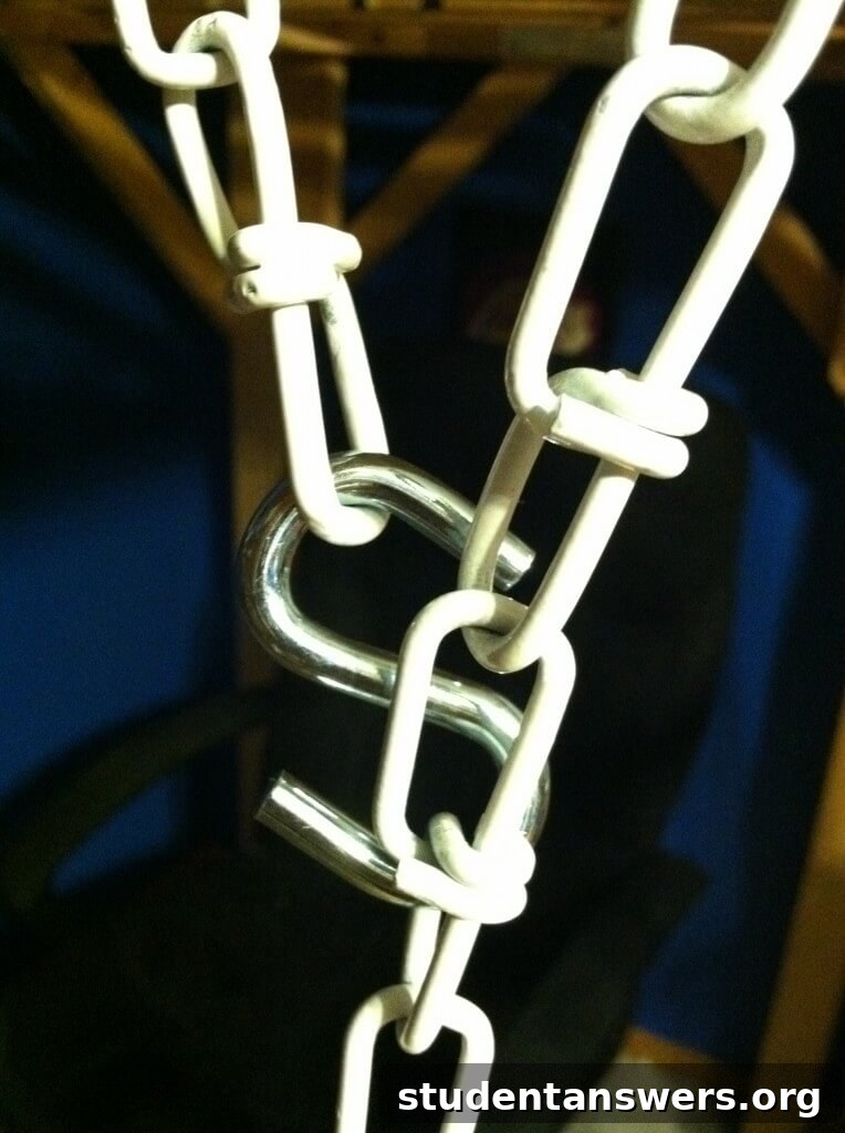 A view looking up at a chain hooked onto the wooden beam of a loft bed.