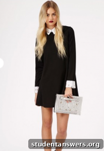Model wearing a black swing dress with a white embroidered collar