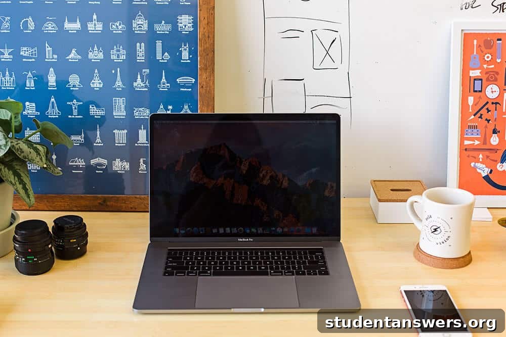 A top-down view of a photographer's desk with a camera, laptop, and notebook.