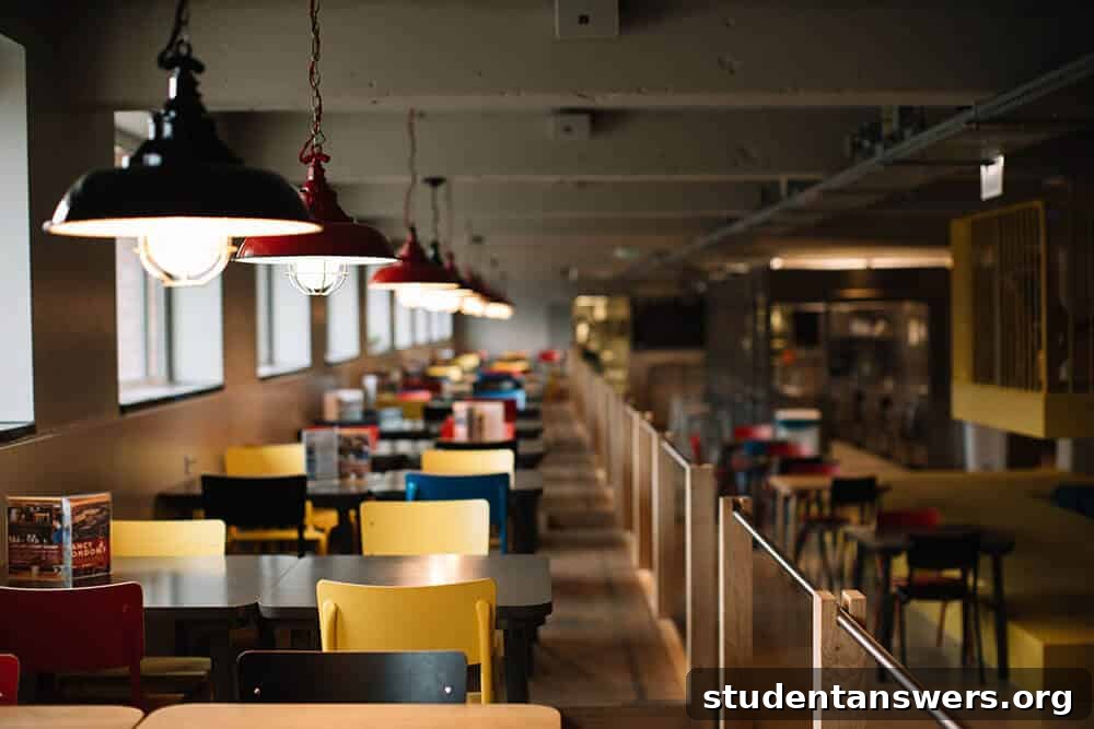 Students eating and studying in a college dining hall.