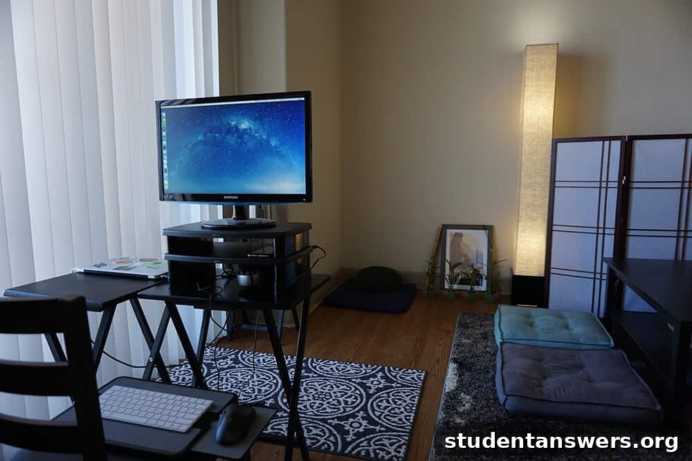 A clean, minimalist desk setup with good lighting and a meditation cushion nearby.