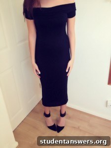 A woman wearing a stylish off-the-shoulder black midi dress.