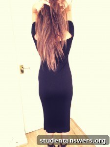 The back view of the sleek and simple off-the-shoulder black dress.