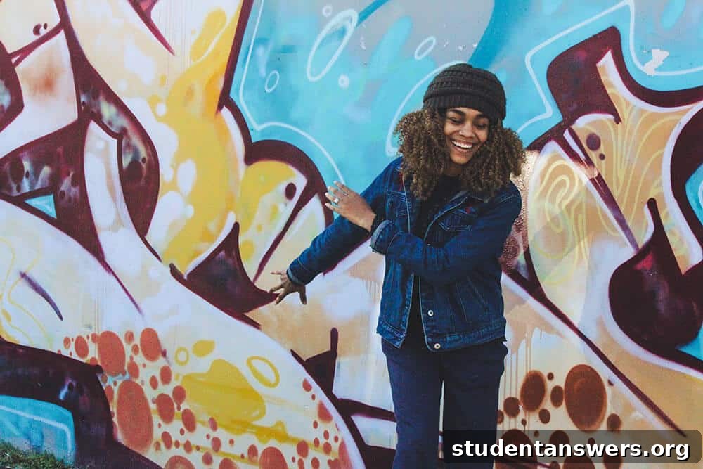 An excited woman celebrating in front of graffiti