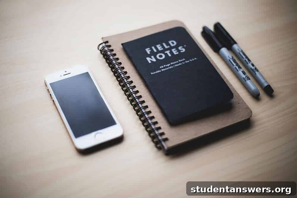 A notebook, phone, and markers on a table, representing planning for personal development