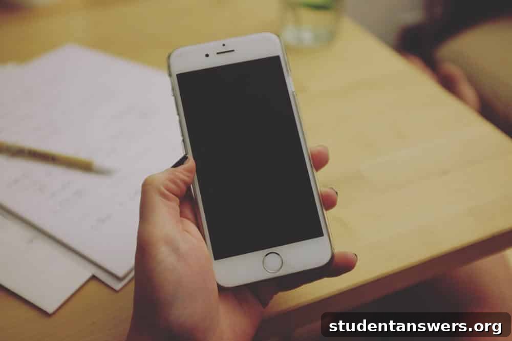 A person holding an iPhone, ready to send a text message.