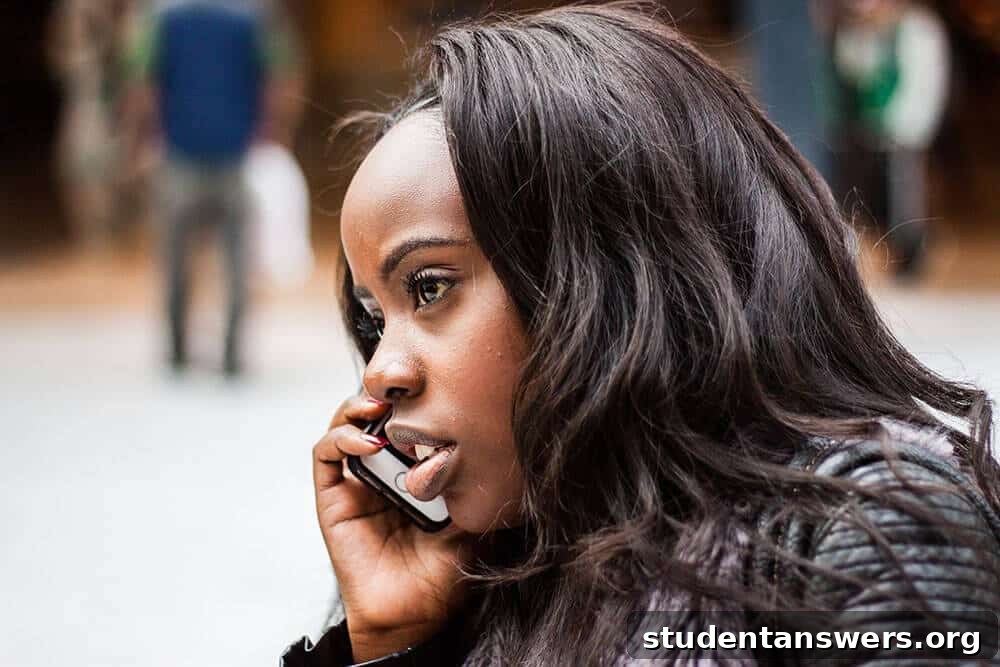 A woman in professional attire talking on her phone outdoors.