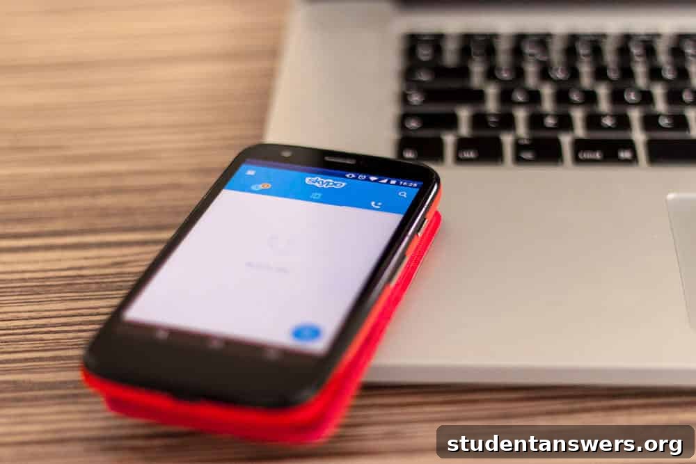 The Skype application open on a smartphone resting on a laptop keyboard.