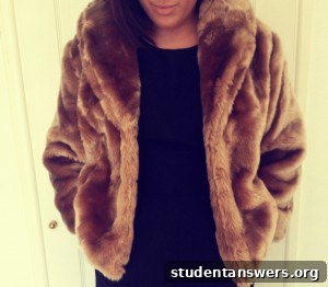 A stylish woman wearing the Phoebe beige faux fur side pocket jacket