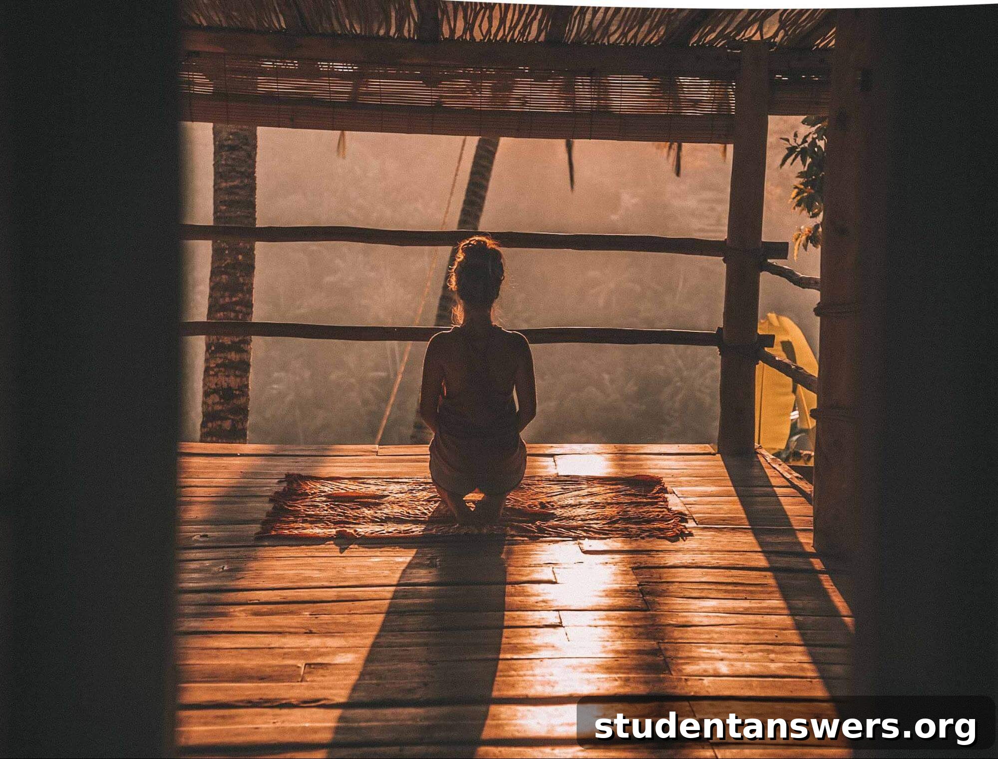 A person meditating peacefully at sunrise, representing the power of routine and mindfulness in building focus.