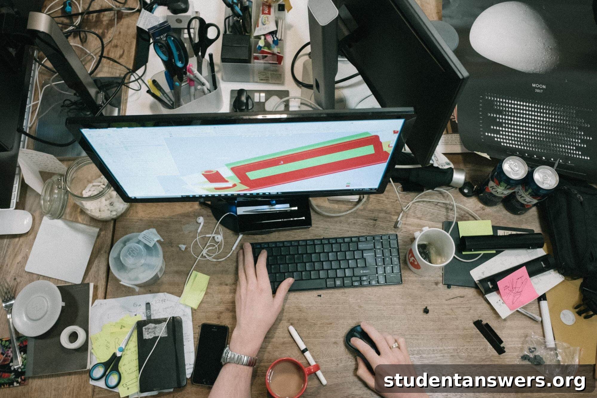 A messy desk filled with various items, suggesting a chaotic work environment