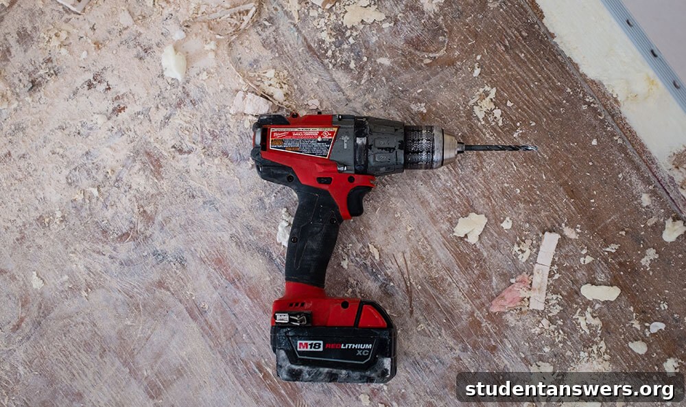 A power drill resting on a wooden floor, symbolizing building something new
