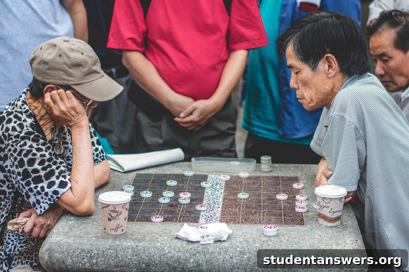 Two people playing a strategic game of Chinese checkers