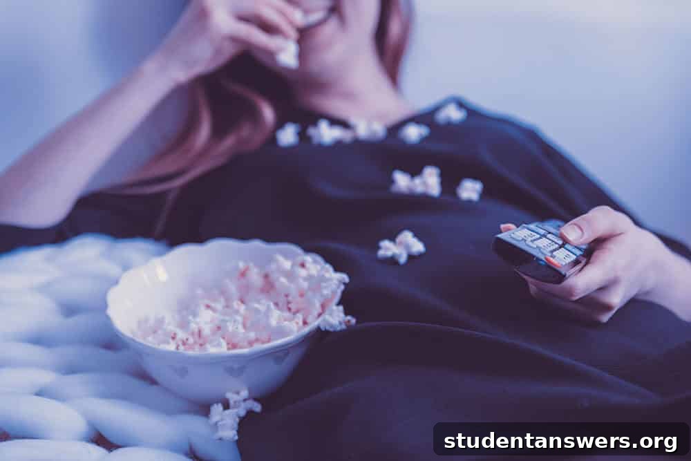 A student enjoying a movie with popcorn, representing entertainment discounts.