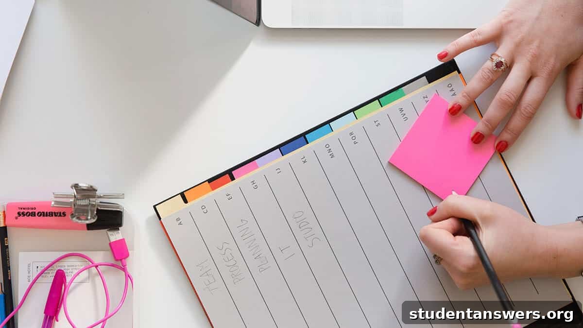 Person writing their goals on a pink sticky note