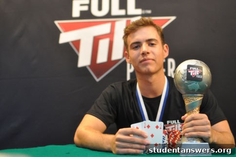 Victorious Cambridge University Poker Captain Mark Hammond smiling and holding the Varsity Poker Match trophy.