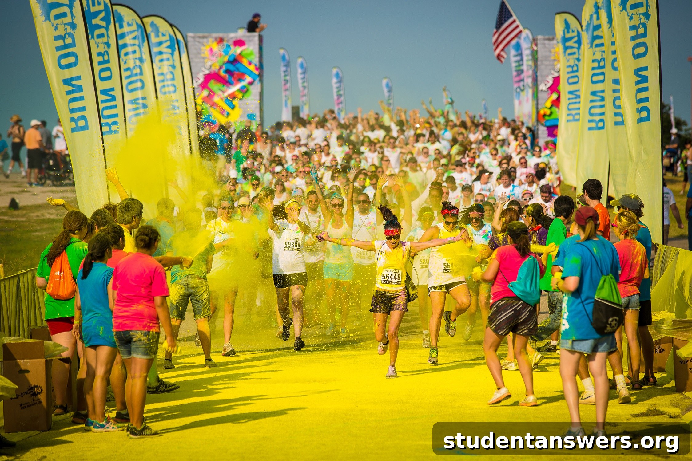 Participants covered in vibrant powders at a Run or Dye color run festival