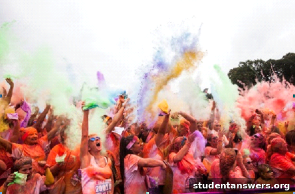 A crowd of participants at a Run or Dye event celebrating by throwing vibrant colored powder into the air.