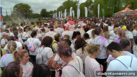 Participants waiting in the starting pen before the Run or Dye 5k begins, all wearing white t-shirts.