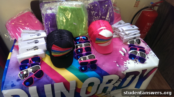 A merchandise stall at the Run or Dye event selling colorful tutus, socks, and other accessories.
