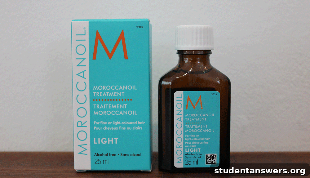 A bottle of Moroccanoil Treatment next to a small dish of argan oil, showcasing its key ingredient.