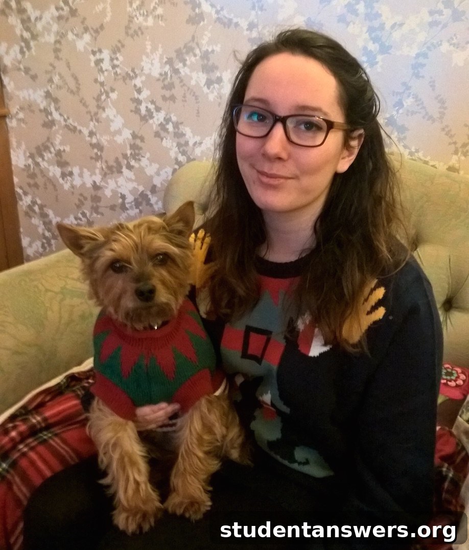 A woman and her dog wearing matching elf-themed Christmas jumpers from Aldi
