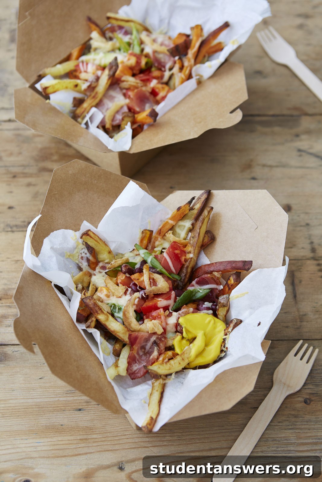 A delicious bowl of crispy loaded fries topped with cheese, bacon, salsa, and fried onions.