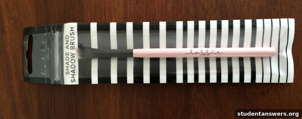 The Lottie London Angled Shade and Shadow makeup brush with pink and blue handle