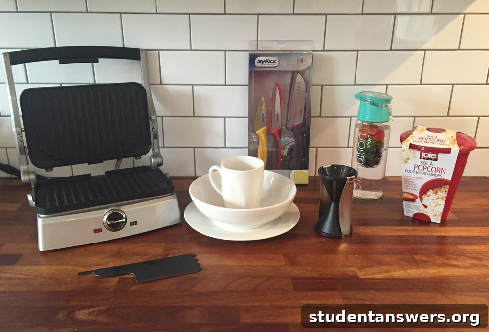 A variety of essential student kitchen items arranged on a wooden surface