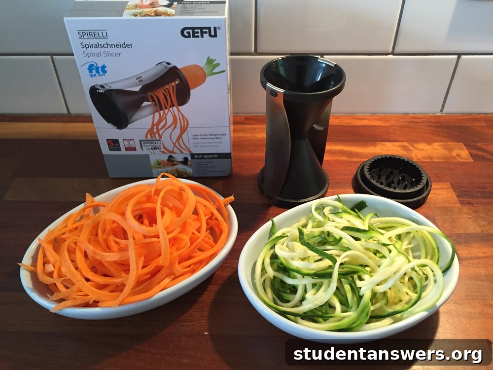 A handheld spiral slicer creating vegetable noodles from a courgette