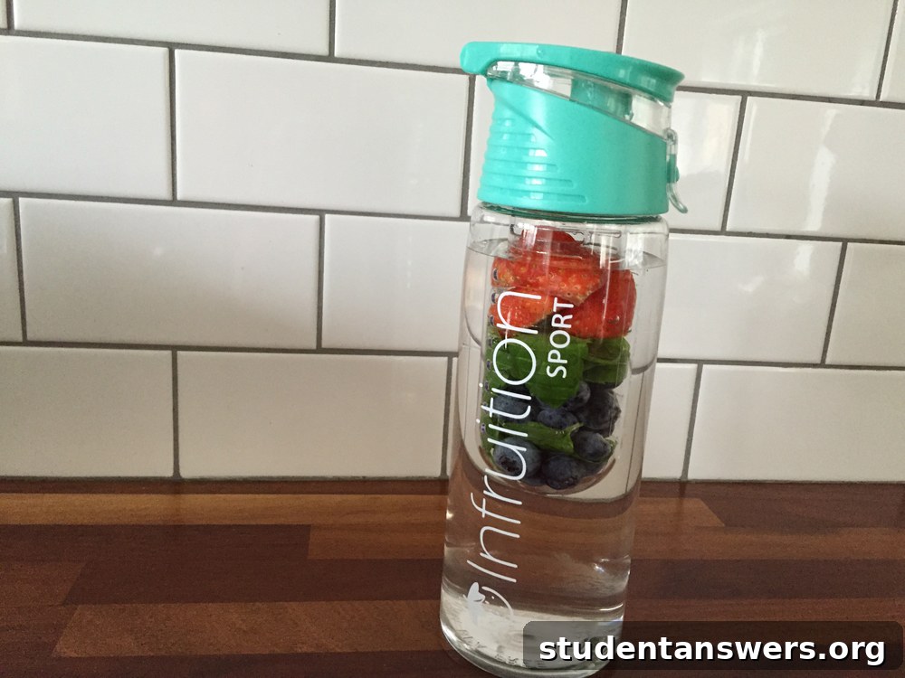 A clear sports water bottle with a mint green cap, featuring an infusion chamber for fruit