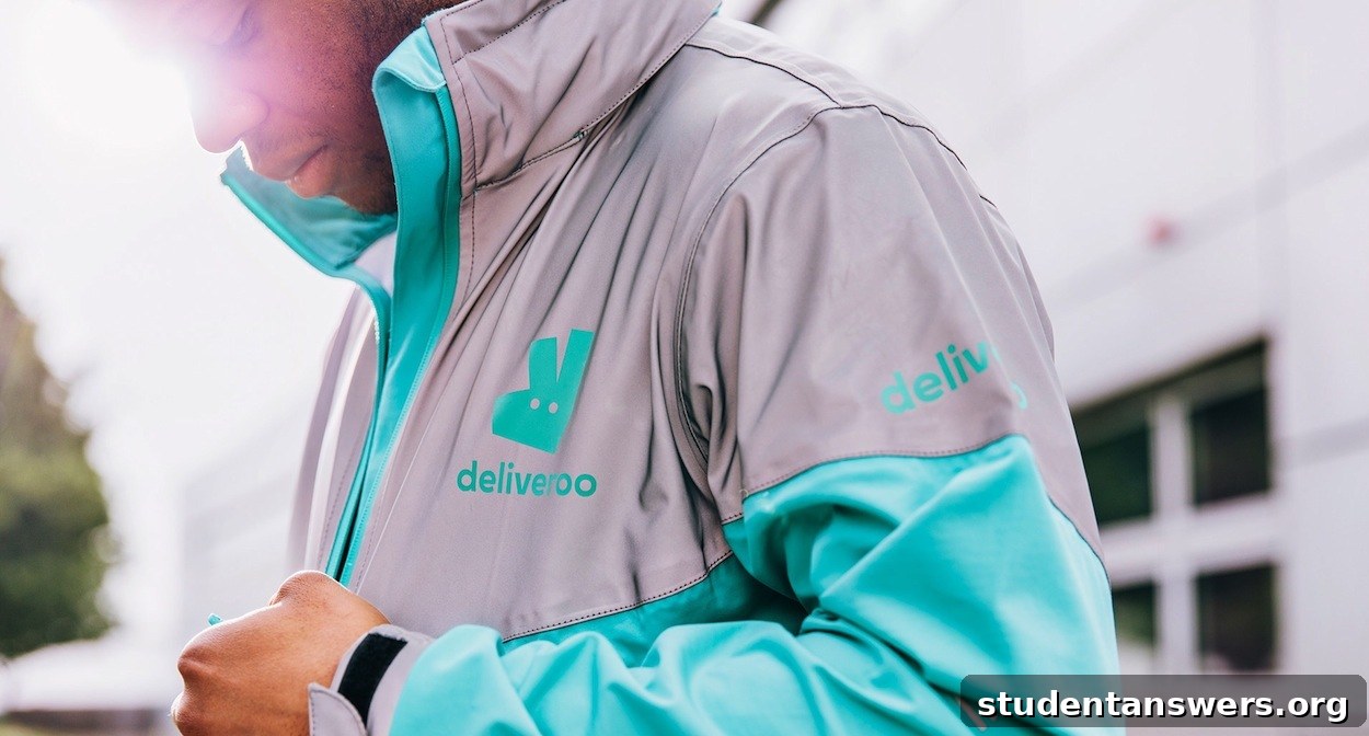 A Deliveroo rider on a bicycle in an urban setting, ready for delivery.