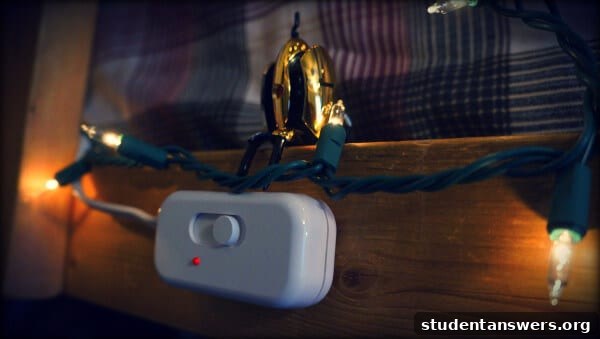 A cozy dorm room with string lights controlled by a dimmer