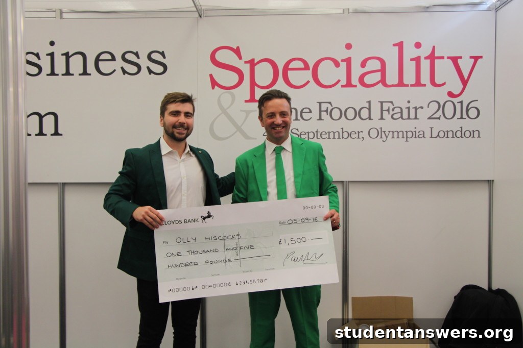 Olly Hiscocks, founder of Olly's Olives, receiving his winner's cheque from Cotswold Fayre