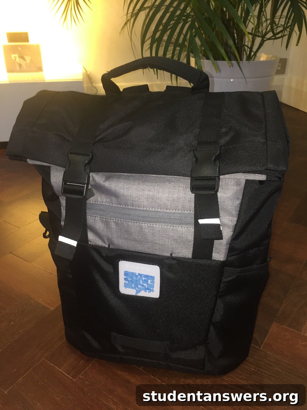 Front view of the black EVERKI ContemPRO roll-top backpack, highlighting its clean design and storage pockets.