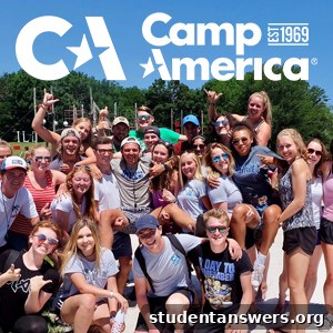 A small group of Camp America staff smiling together outdoors