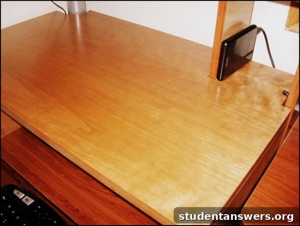 A custom-built wooden riser that converts a regular desk into a standing desk.