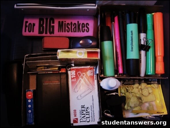 An office drawer neatly organized with repurposed cardboard boxes.