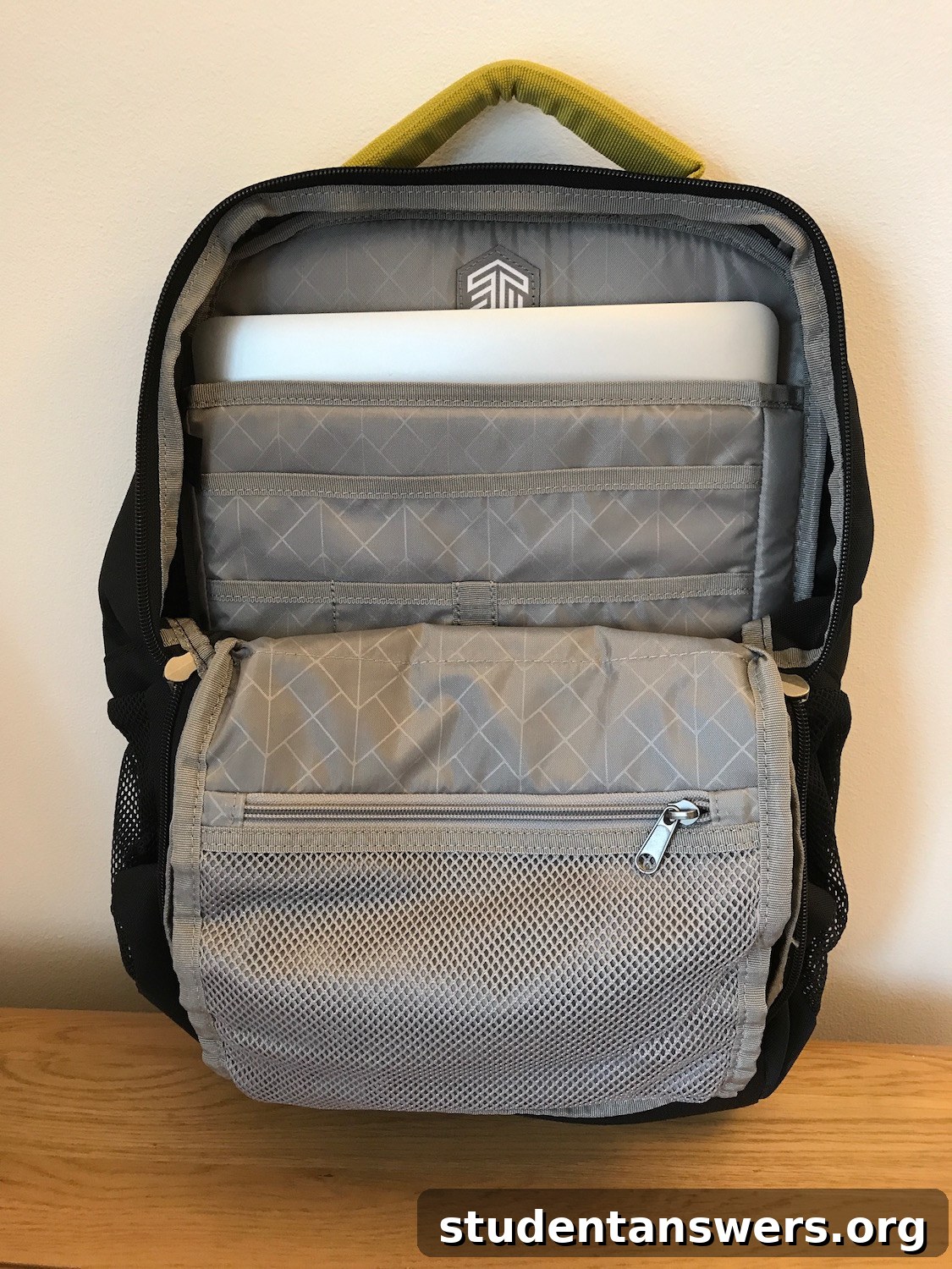 Inside view of the STM Saga backpack showing the laptop compartment and organizer pockets
