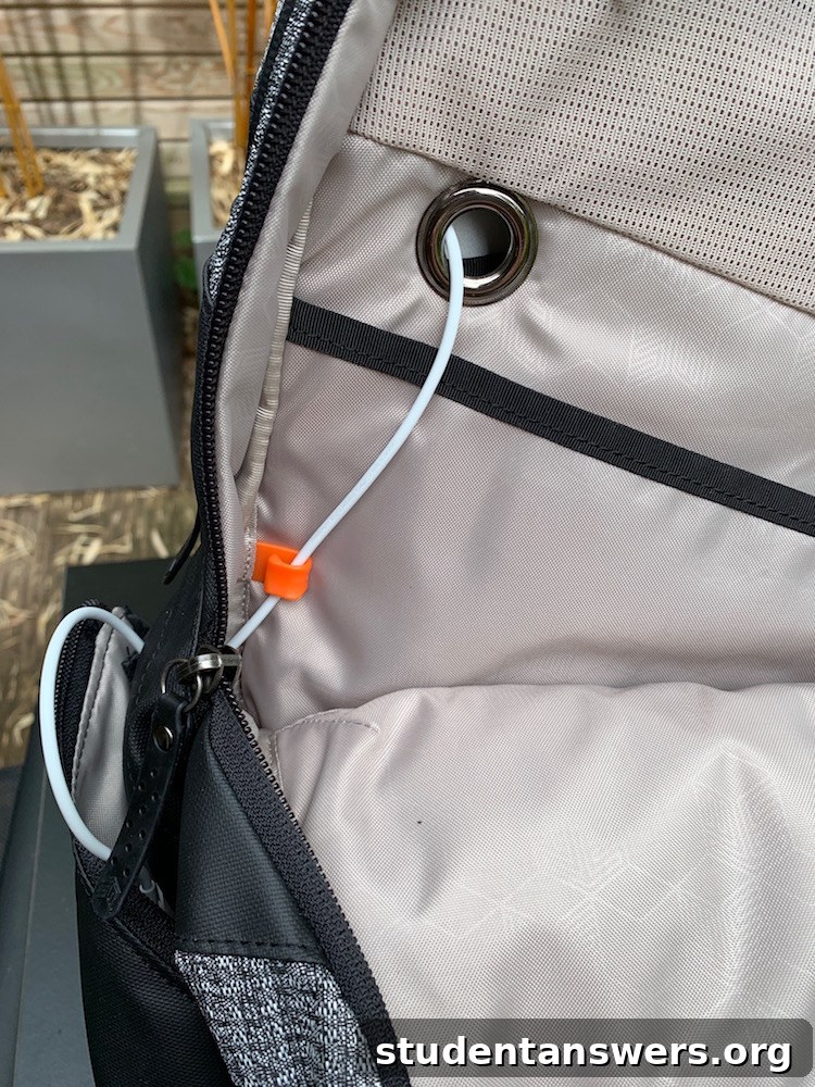Cable routing through the backpack's internal compartments