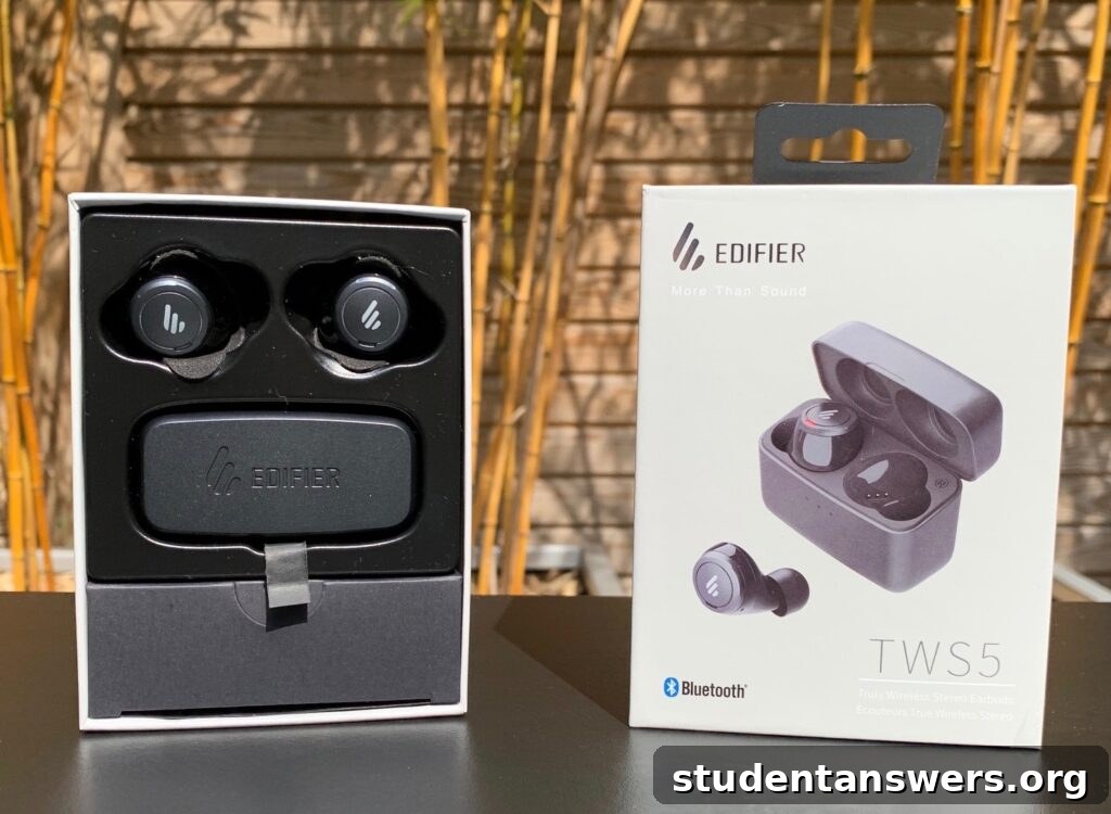 Edifier TWS5 wireless earbuds with charging case on a wooden surface