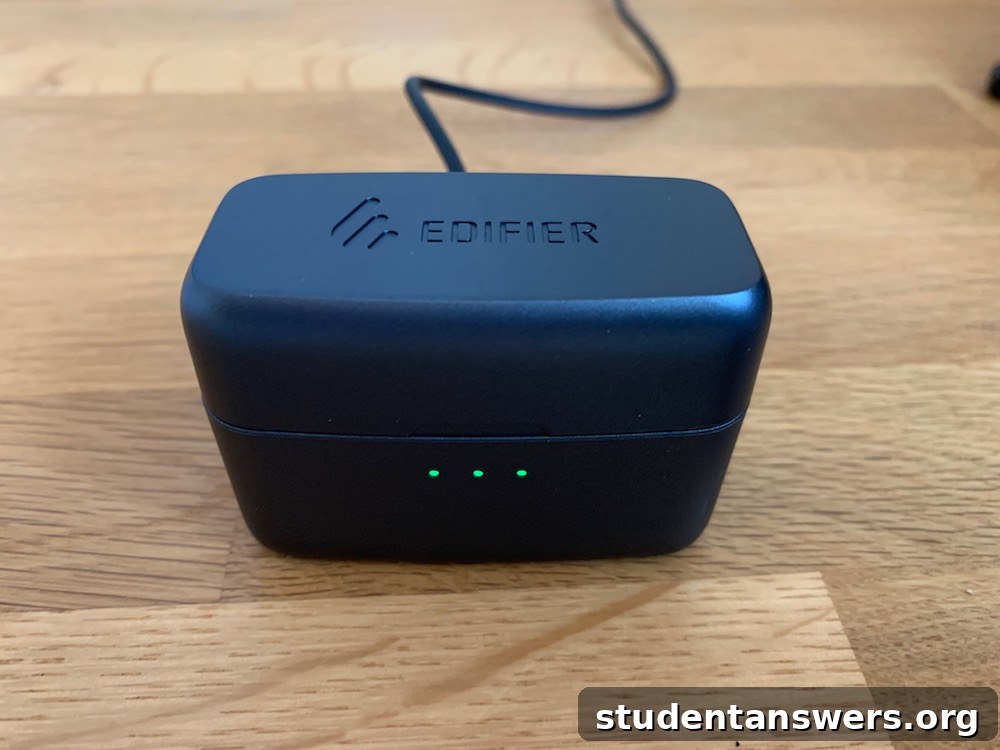 The Edifier TWS5 earbuds placed next to their charging case